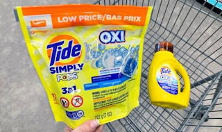 hand holding Tide Simply Pods in front of cart