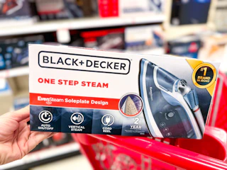 hand holding a black+decker steam iron on a target cart