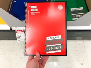 hand grabbing notebook from Target store shelf