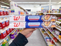 hand holding two walgreens aluminum foil packs