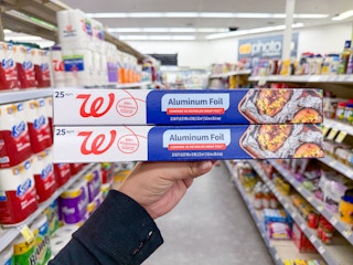 hand holding two walgreens aluminum foil packs