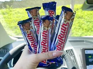 six baby ruth candy bars held in hand