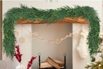 LZNPA Christmas Cedar Garland draped on a fireplace mantle.