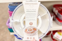 hand holding up a rotating snack box