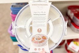 hand holding up a rotating snack box