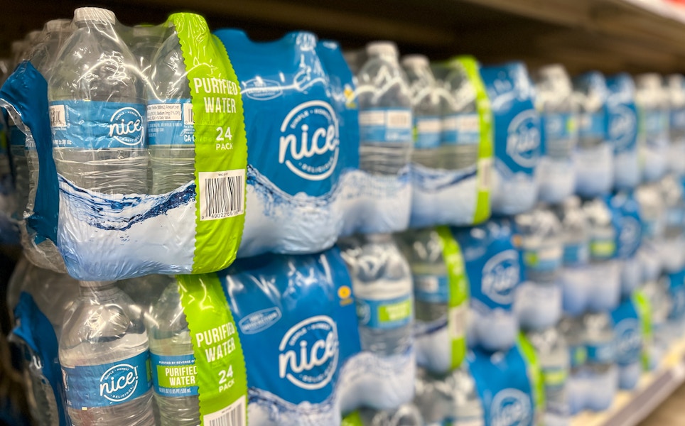 angled shot of store shelf with packs of water