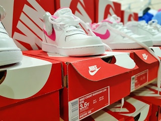 white and pink women's sneakers on display at the Nike store