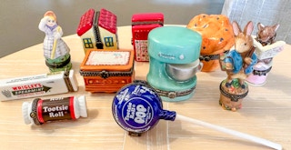 A group of porcelain hinged boxes together on a table