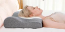 a person laying on a cervical pillow