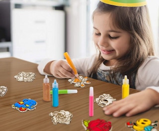 a girl drawing on window stickers