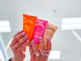 hand holding 3 gold bond hand creams at target