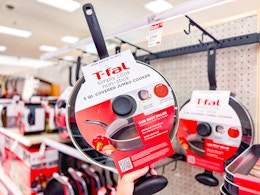 hand holding a t-fal jumbo cooker in front of cookware at target