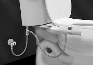 A bidet attachment on a toilet.