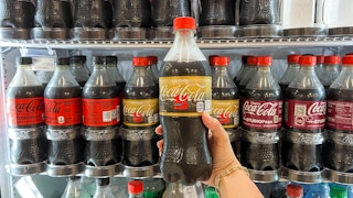 coca cola ultimate soda pop drink in store drink cooler being held