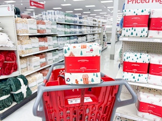 target holiday sheet sets sitting on shelves and a cart