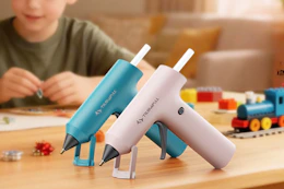 blue and pink cordless hot glue guns on a wooden table