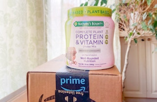 a tub of nature's bounty protein mix resting on an amazon prime box