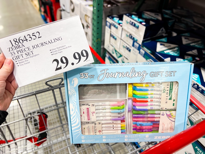 person holding a $29.99 price tag by a journaling gift set