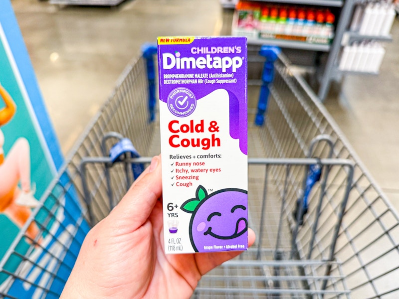 hand holding childrens dimetapp over walmart cart