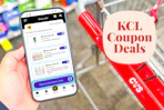 hand holding a smartphone displaying KCL Coupons next to a cvs shopping cart