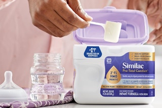 a woman scooping similac formula