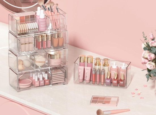 clear stackable drawers with makeup in a pink room