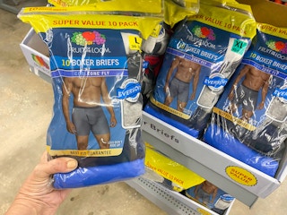 hand holding a super value pack of fruit of the loom boxers at walmart