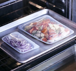 Two Stasher food storage bags in an oven.