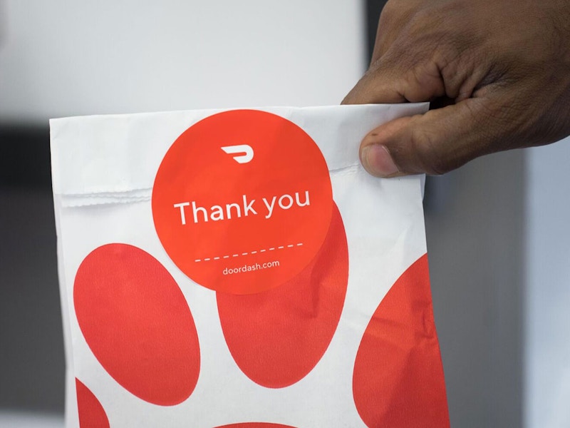 a hand holding a to-go Chick-fil-A bag that says thank you