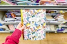 hand holding a notebook at dollar general