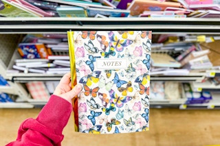 hand holding a notebook at dollar general