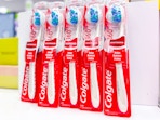 5 colgate 360 whitening toothbrushes sitting on a target table