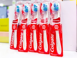 5 colgate 360 whitening toothbrushes sitting on a target table