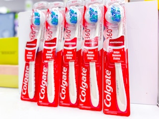 5 colgate 360 whitening toothbrushes sitting on a target table