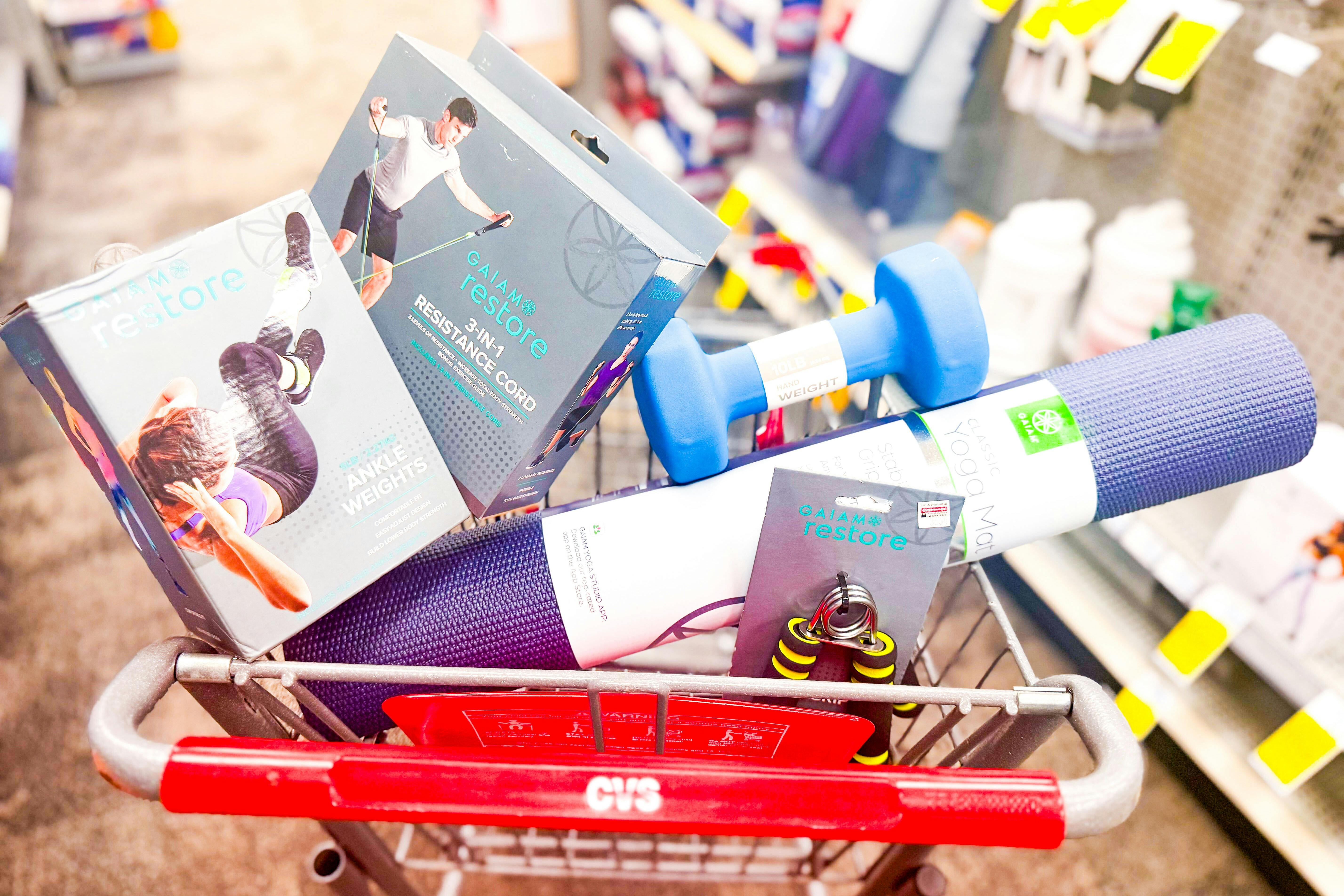 resistance bands, yoga mat, hand weights, and more workout equipment in a cart