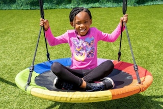 child playing on a saucer style swing