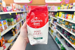 hand holding a bag of seattles best coffee in a store aisle