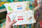 hand holding huggies baby wipes packs