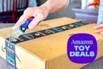 person cutting open an amazon box
