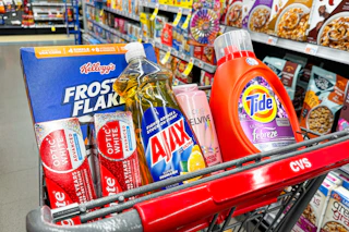 colgate toothpaste, ajax dish soap, frosted flakes cereal, tide detergent, and loreal elvive shampoo in a cart