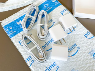 chargers and charging cords on an Amazon mailer