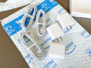 chargers and charging cords on an Amazon mailer