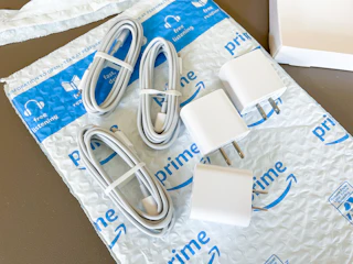 chargers and charging cords on an Amazon mailer