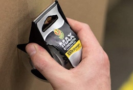 a person using packaging tape on a box