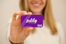 a woman holding a zulily gift card