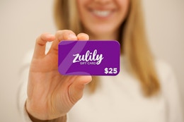 a woman holding a zulily gift card