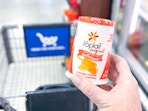 hand holding a yoplait yogurt cup