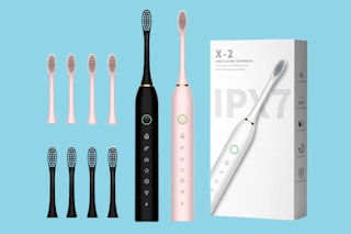 Two electric toothbrushes, one pink, one black, four replacement heads for each, white box.