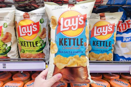 hand holding a bag of lays kettle cooked chips