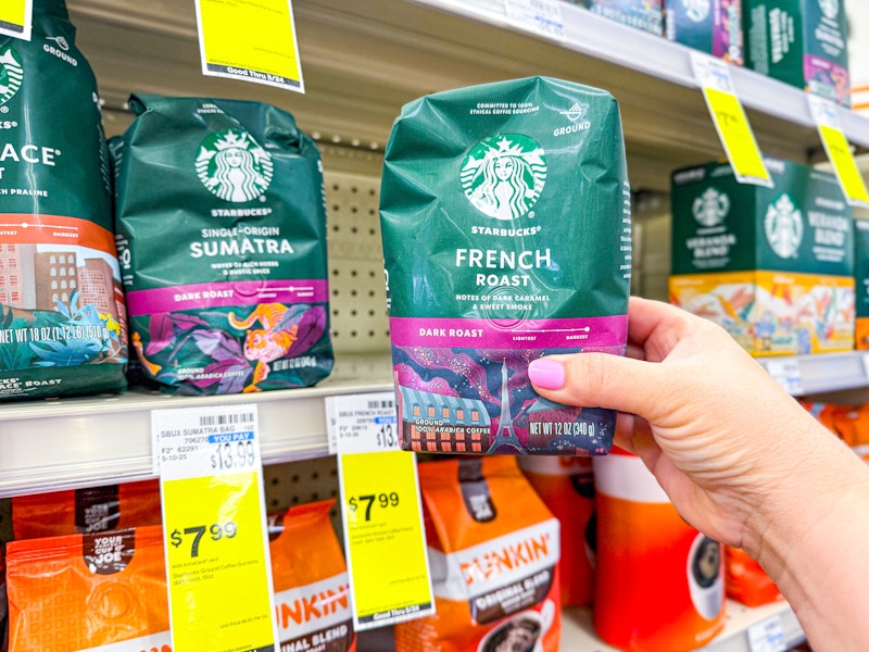 person grabbing a bag of starbucks coffee off a shelf